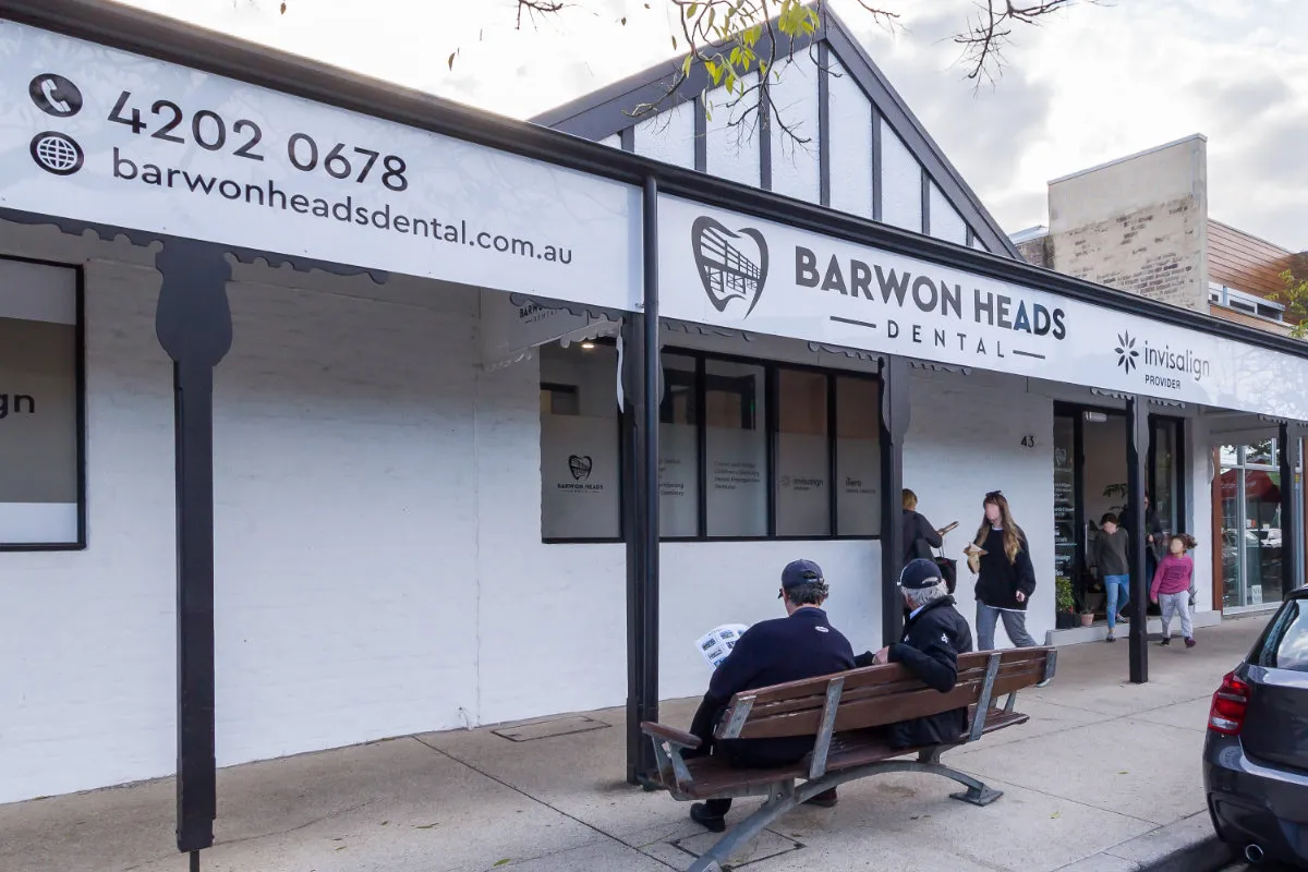Street view of Barwon Heads Dental with patrons on a footpath bench under the verandah.