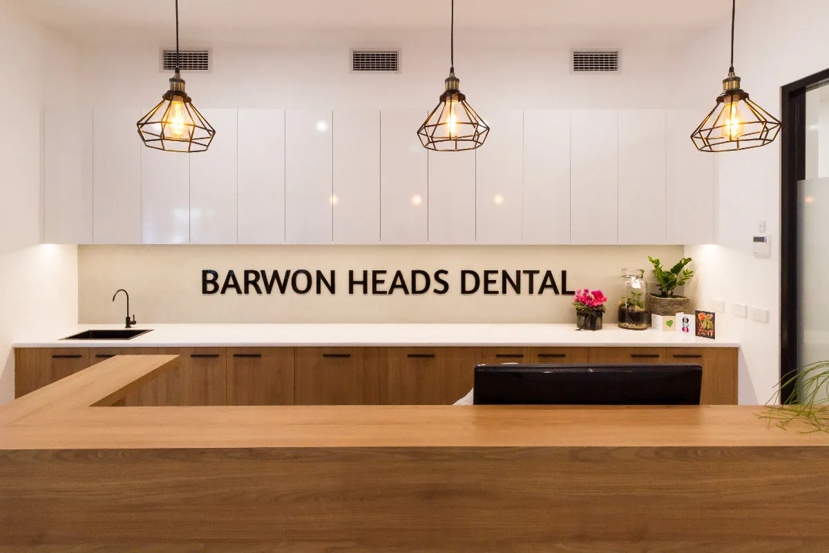 Reception kitchenette at Barwon Heads Dental with timber base cabinets and three pendant lights.