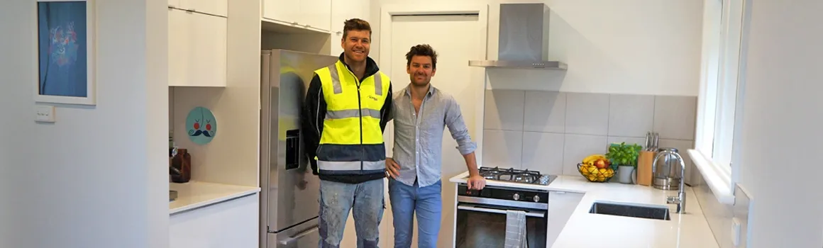 A Burmpro builder beside client George Stuckey in the completed Greensborough kitchen renovation.
